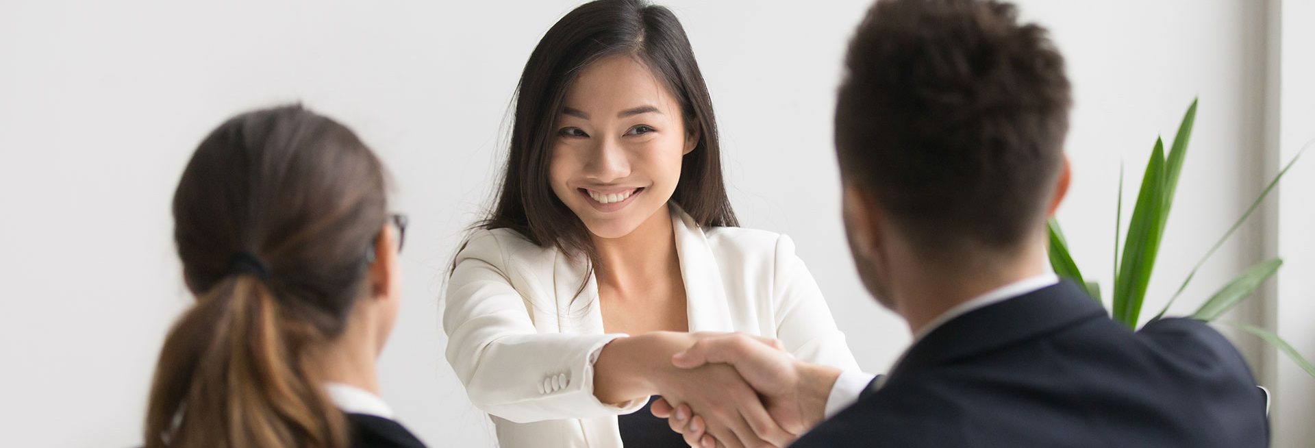A young woman shaking hands after a meeting